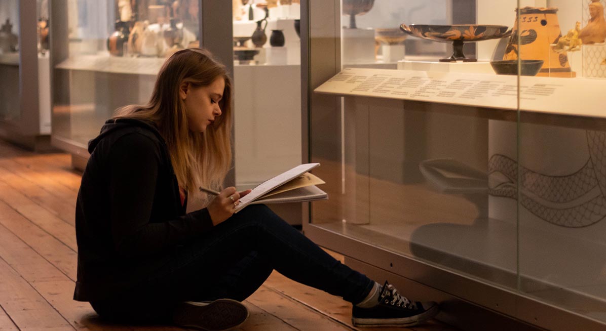 A student takes notes in the Great North Museum: Hancock